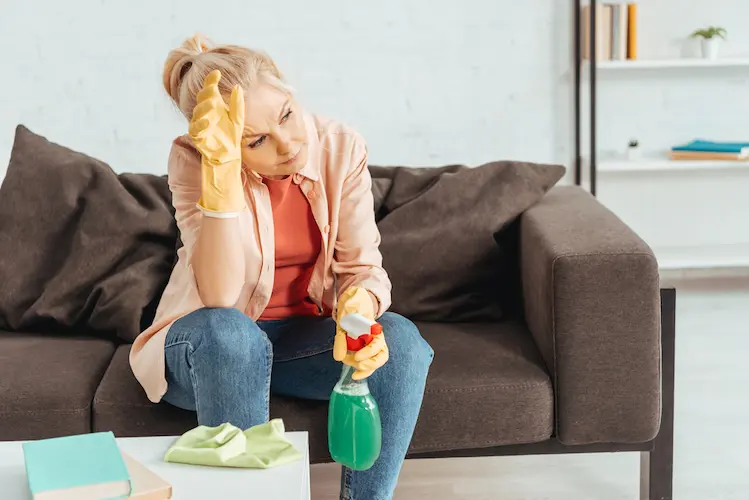 woman taking a break from cleaning a house