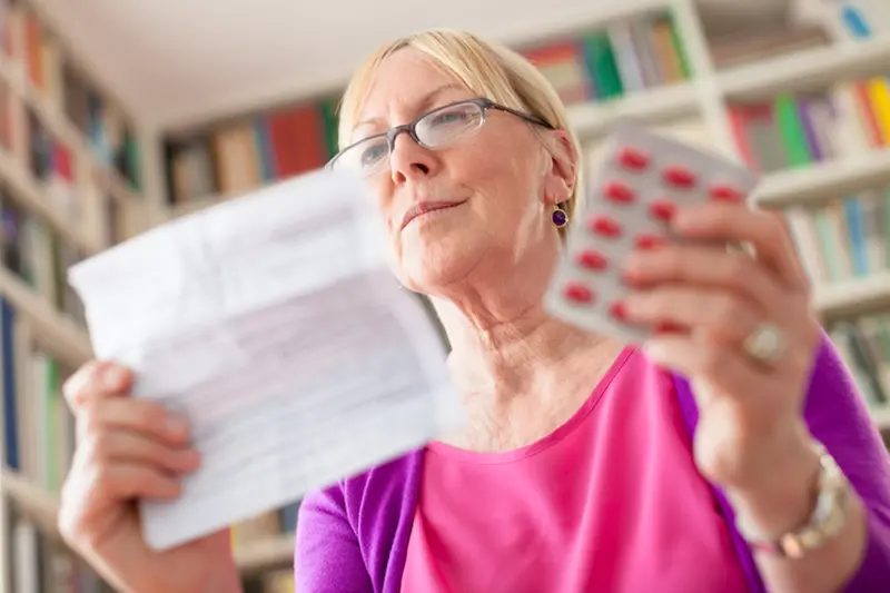 woman reading prescription instructions