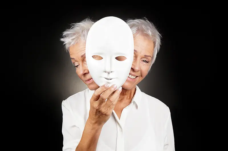 a woman holding a mask