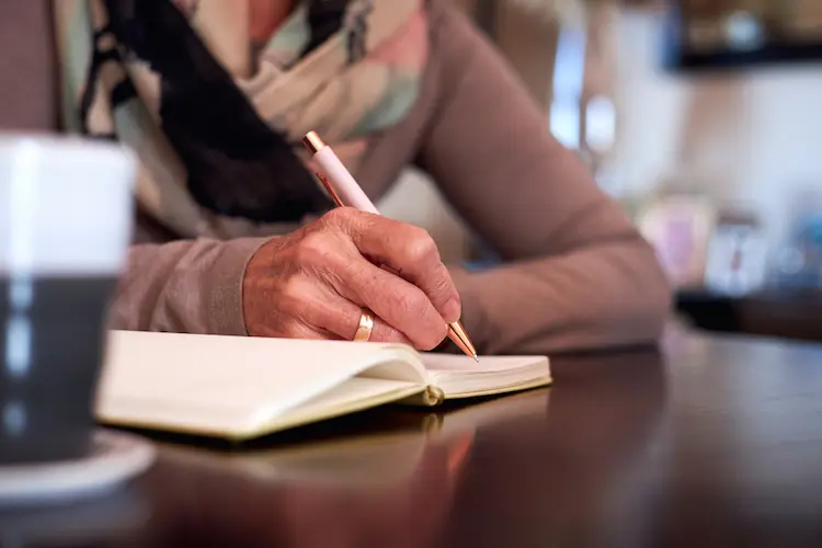 a person writing in a book