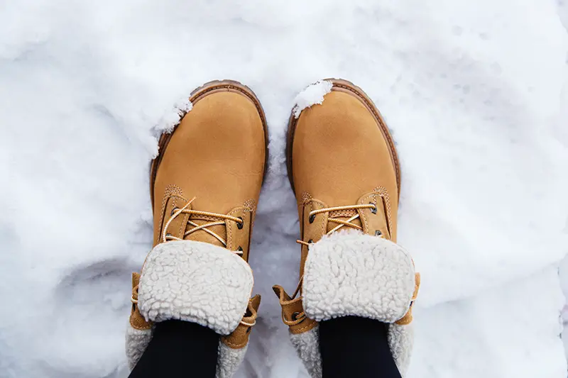 a pair of boots in the snow