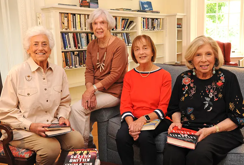 a group of senior citizens holding books at Waverly Heights