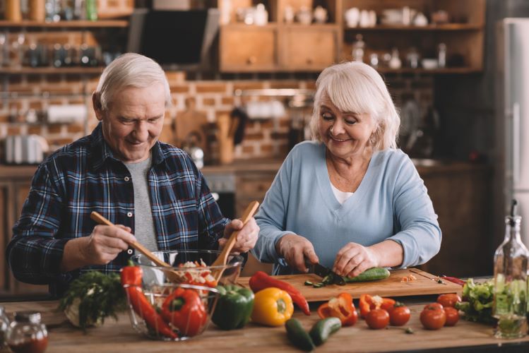 an older couple cooking nutritious food