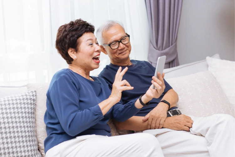 an older couple looking at a cell phone