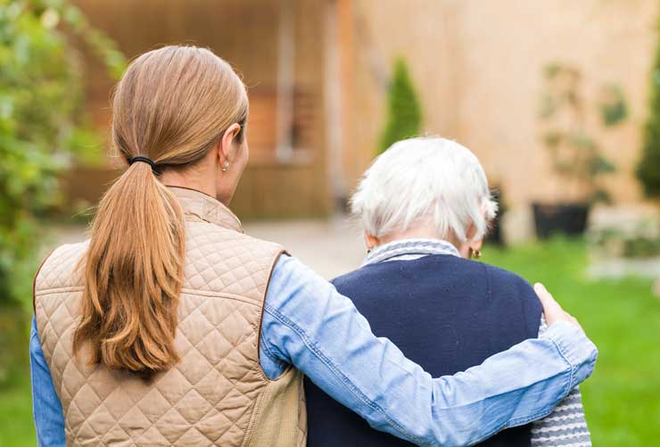 a young woman with her arm around an older woman